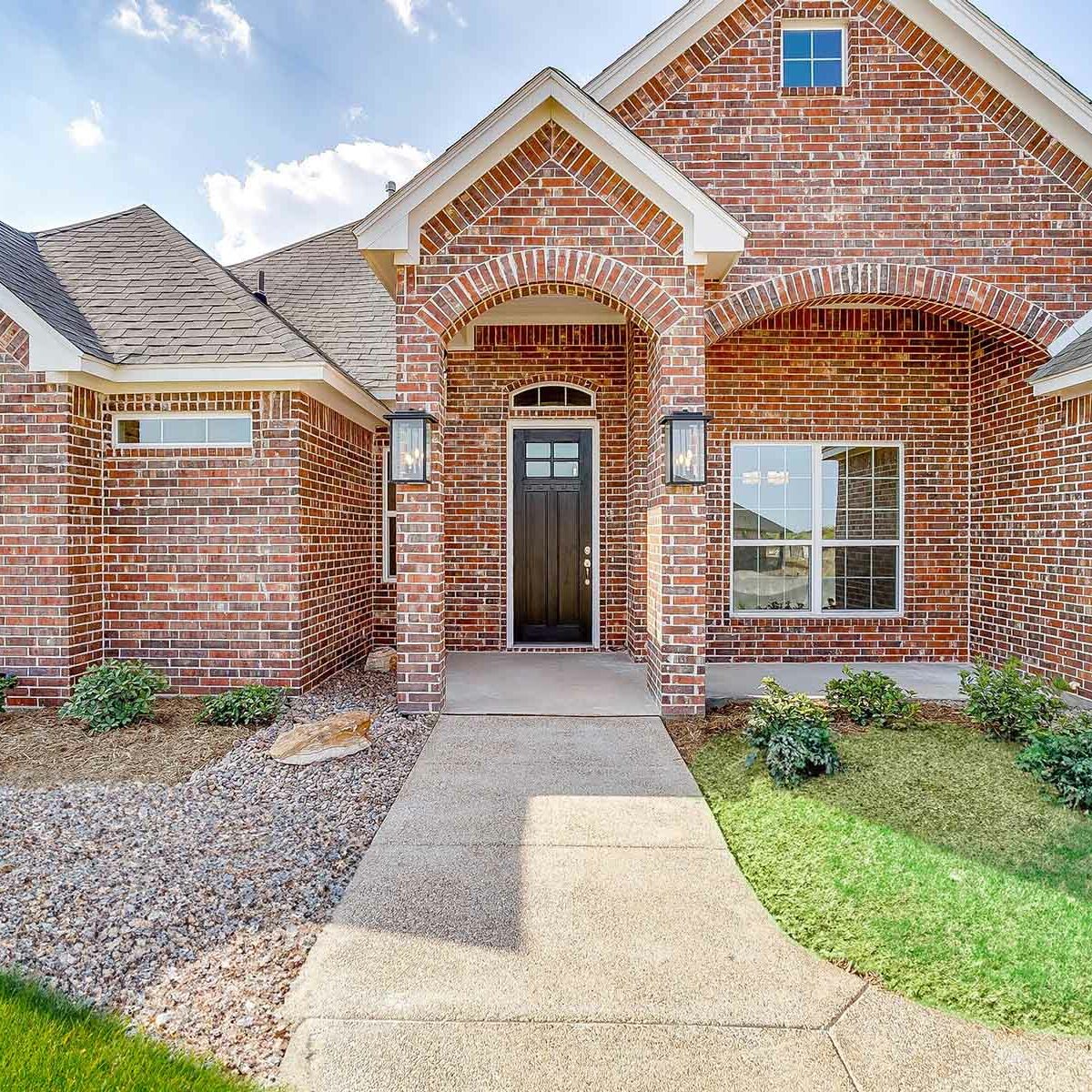 Front of a custom brick home by Steve Hawkins Homes in Benbrook TX